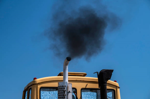 An image of a diesel truck emitting black smoke from an exhaust pipe..