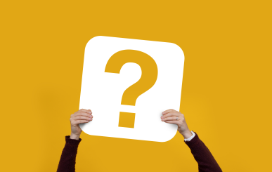 Hands holding up a question mark symbol.